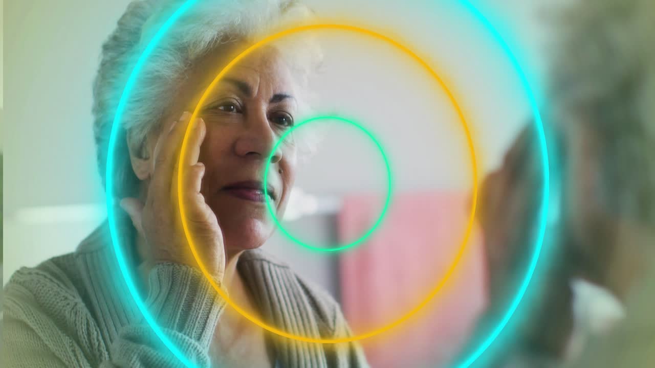 Senior woman touching cheek at vanity mirror touch causing animated rings covering face for beauty