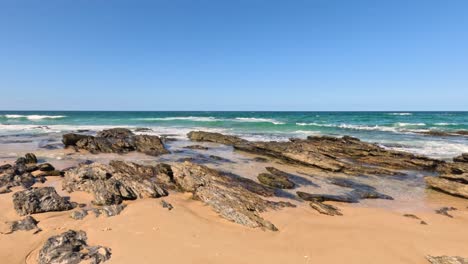 waves crashing on rocky beach shore