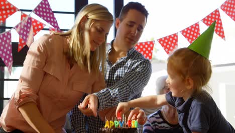 Mother-and-son-decorating-birthday-cake-at-home-4k