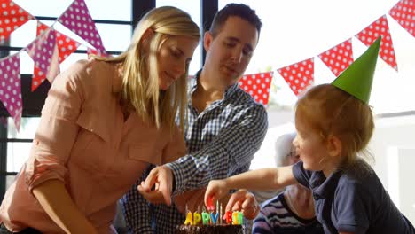 mother and son decorating birthday cake at home 4k