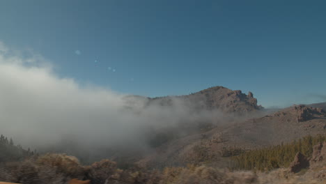 a beautiful mountain landscape through the window of a moving car