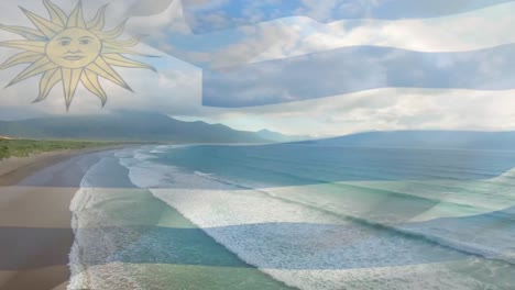 digital composition of waving uruguay flag against aerial view of beach and sea waves