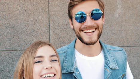 happy couple taking a selfie outdoors