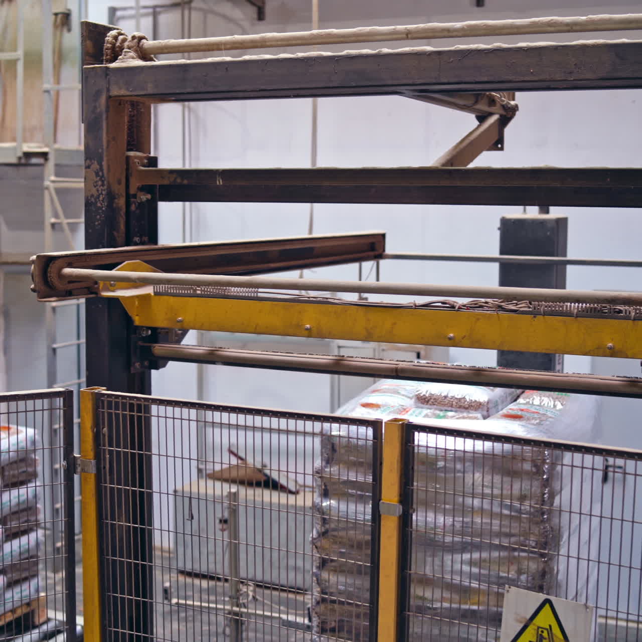 Industrial robotic machine in factory. Modern robot collects packed objects. Automated equipment at work.