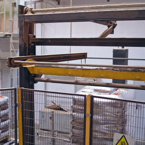 industrial robotic machine in factory. modern robot collects packed objects. automated equipment at work.