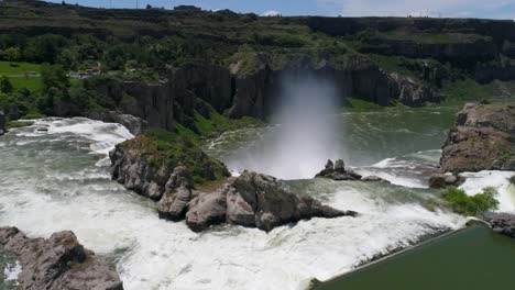 a 4k drone shot of shoshone falls, a raging waterfall, which often reflects rainbows, located along the snake river, only 3 miles away from perrine bridge and twin falls, idaho