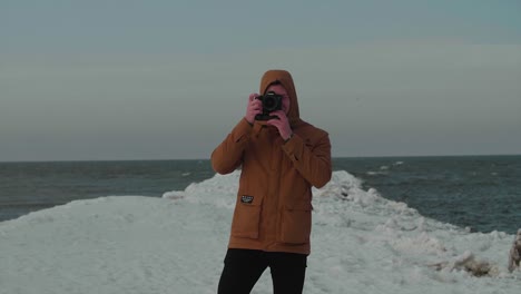 man taking photo in winter