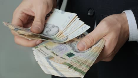 men's hands quickly count banknotes. businessman counts ukrainian hryvna in the hands.