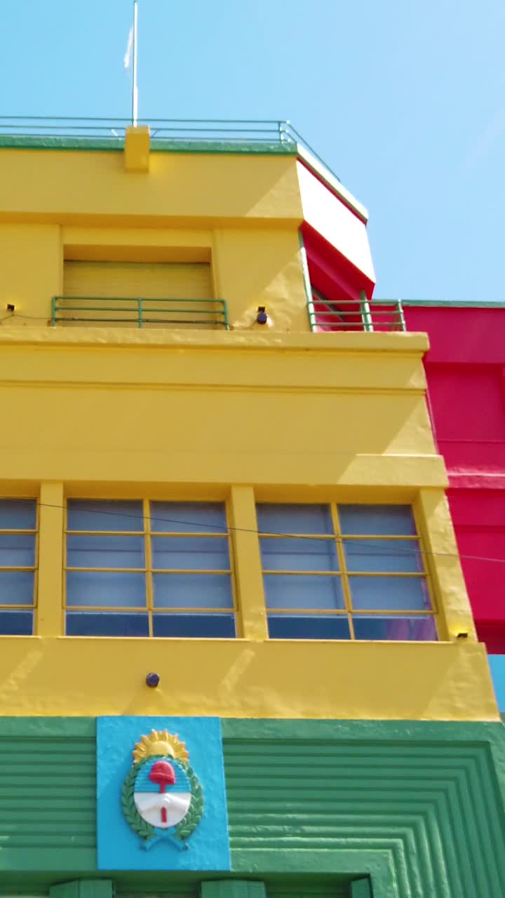Ángulo bajo del colorido edificio de la escuela pública Caminito La Boca en Buenos Aires, un hito histórico de viaje argentino.