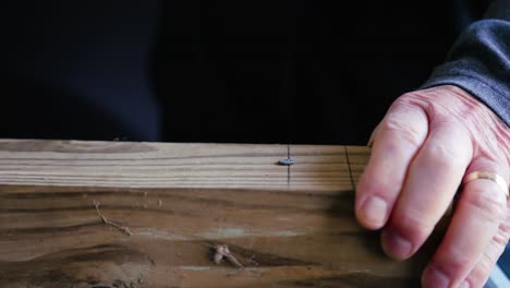 finishing off a nail into wood in slow motion