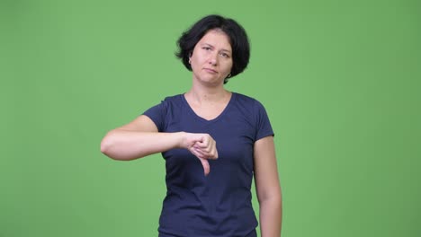 beautiful woman with short hair giving thumbs down