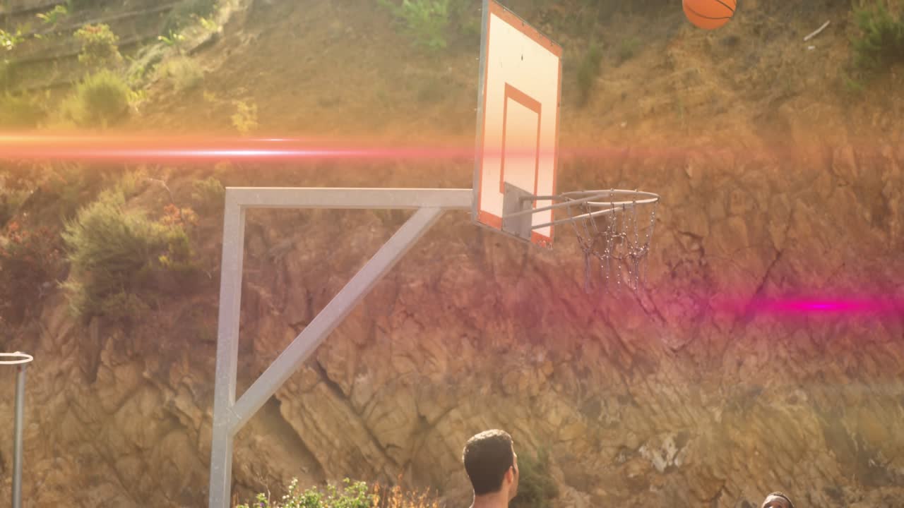 Male shooter holding basketball and preparing jump shot on outdoor court, attempting to score