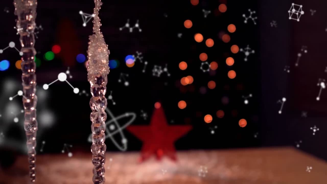 animación de moléculas sobre decoraciones navideñas y puntos de luz sobre fondo negro