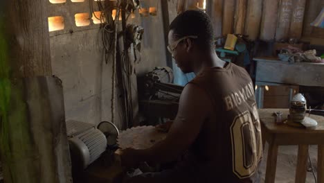 working class labor conditions of black labor in africa, young male working in a metallurgic factory