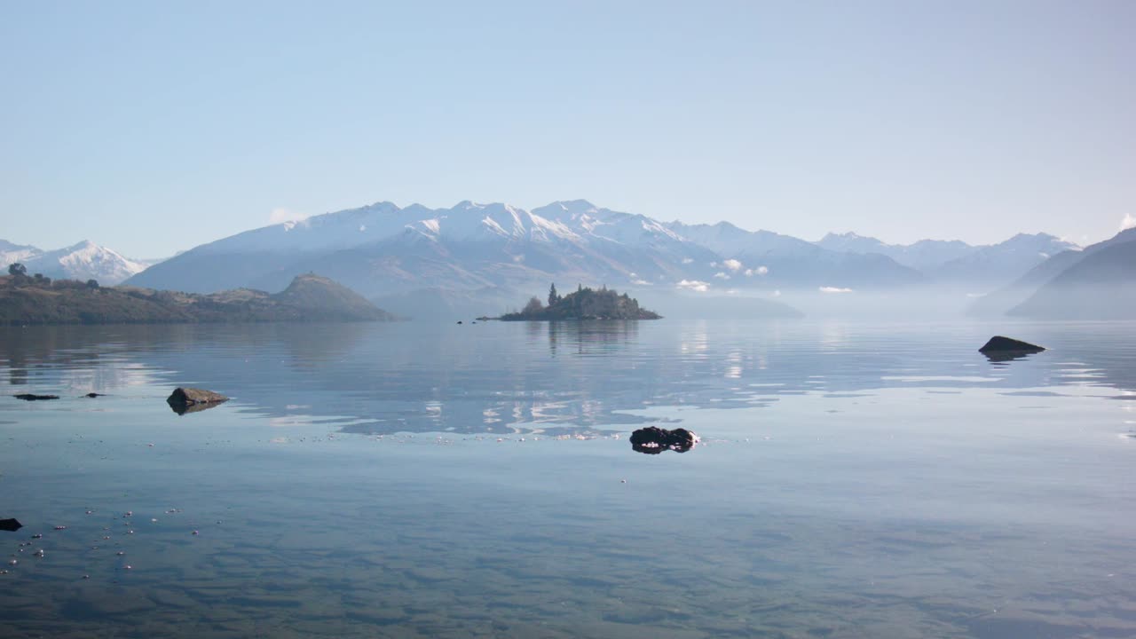 A low shot of Ruby Island in Lake Wanaka on a clear day, New Zealand