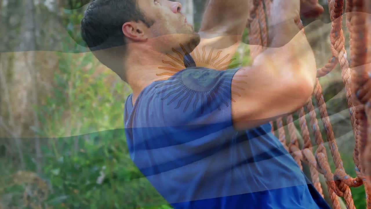 animación de la bandera de la argentina sobre un hombre musculoso y fuerte escalando