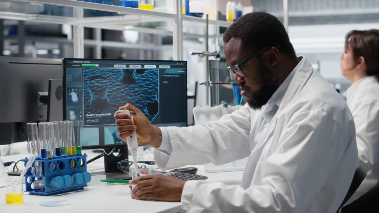 Vertical video Histology technician uses pipette to extract reagent from glass into test tube