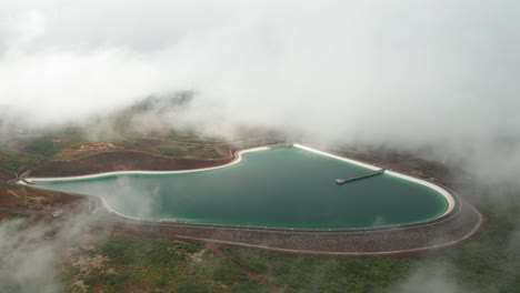 aerial of barragem do pico da urze in mist, water reserve of madeira island