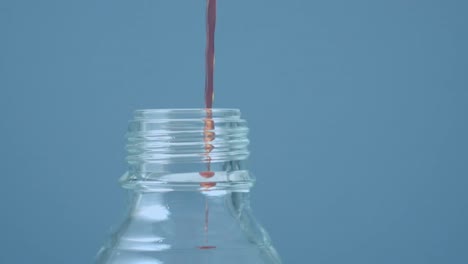 animation of dots floating over liquid pouring into bottle