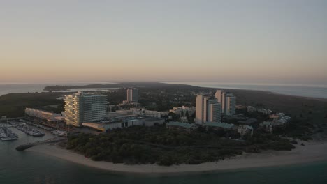 Aerial-and-panoramic-view-of-Troia-Peninsula-on-early-morning-of-sunny-day,-near-Lisbon