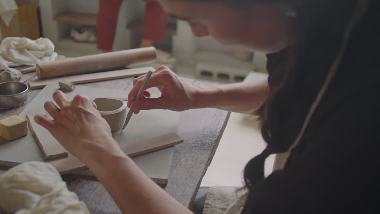 Woman Modeling Clay at Pottery Lesson