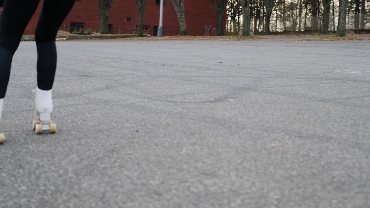 Slow Motion of Red Haired Girl Riding Rollerskates on Asphalt