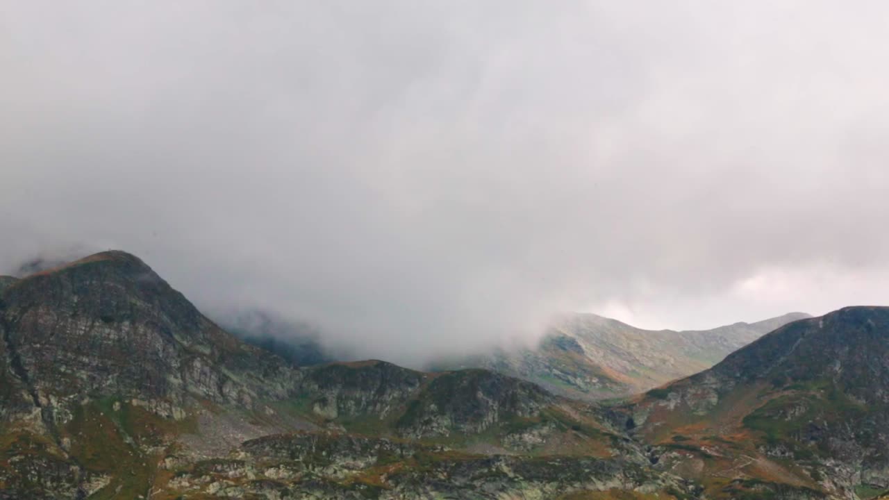 Clouds passing through a mountain range