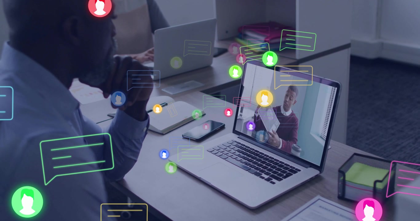 Mature man powering laptop starting business conference with icons swirling boosting collaboration