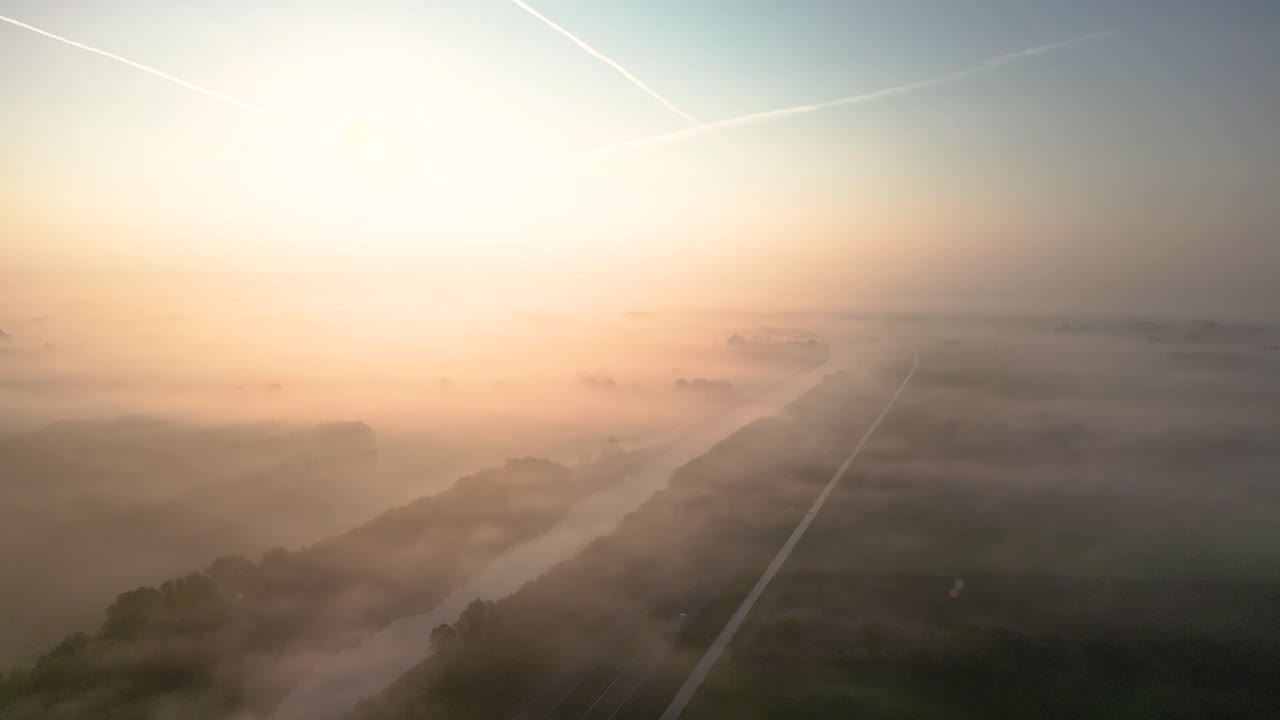 Misty Sunrise Over a River and Road