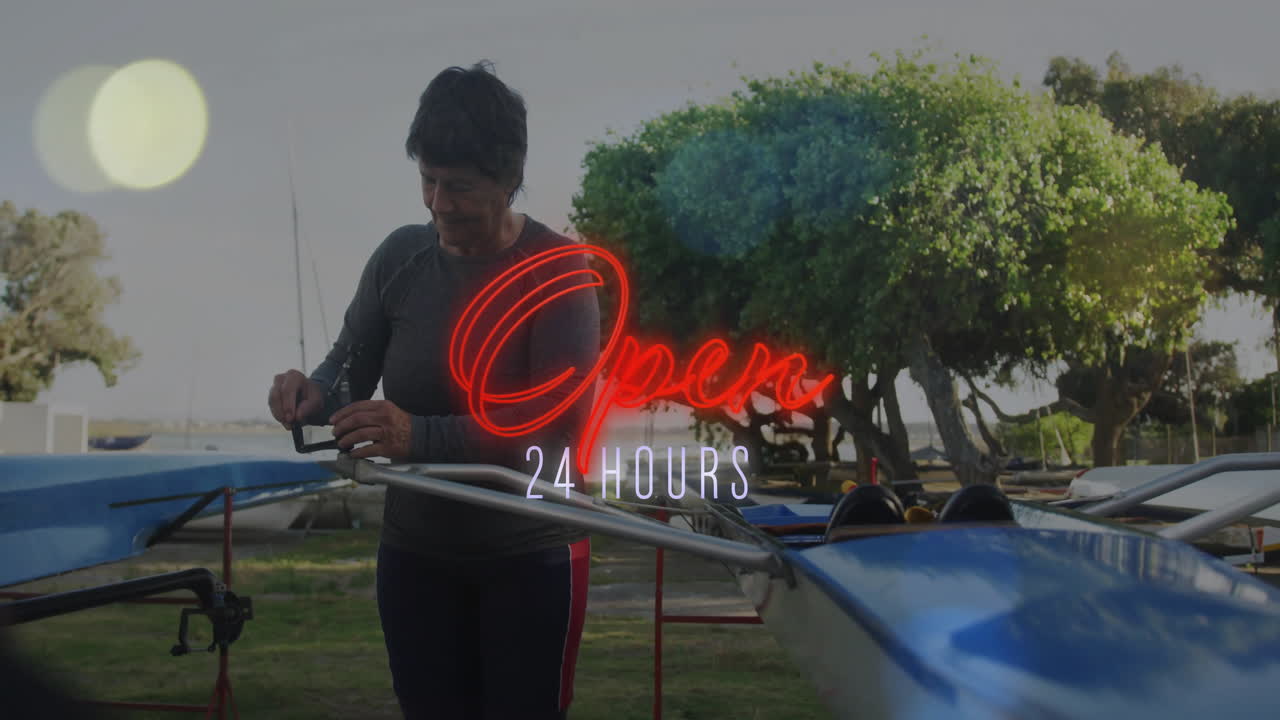 Senior woman adjusting boat rigging in maritime boatyard, displaying animated hardware data icons