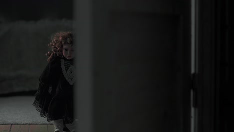 creepy doll standing on the other side of a door