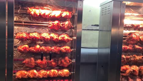 roasted chicken and pork on rotisserie