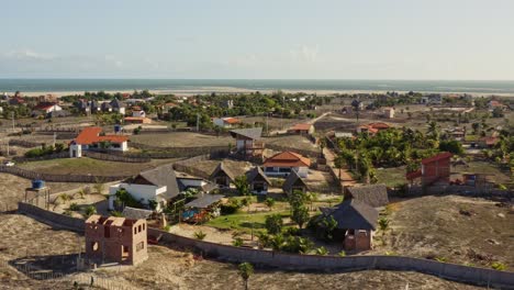 Drone-crane-motion-toward-lush-Brazilian-hotel-resort-garden-with-small-lodges