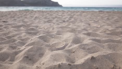 Woman-walking-on-the-white-sand-of-a-mediterranean-beach