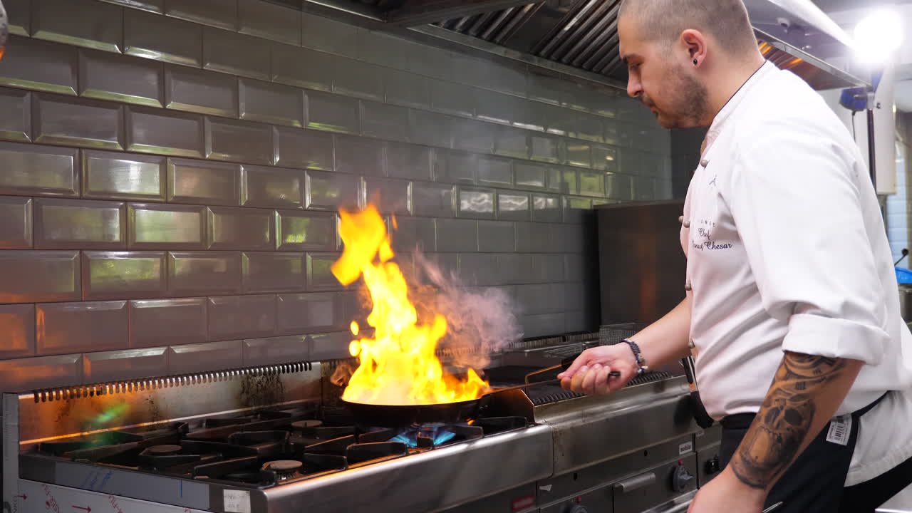 Chef Flambeing Food in a Restaurant Kitchen