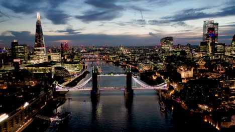 Aerial-View-of-London-over-the-River-Thames-including-Tower-Bridge,-Shard-and-the-Tower-of-London-at-twilight