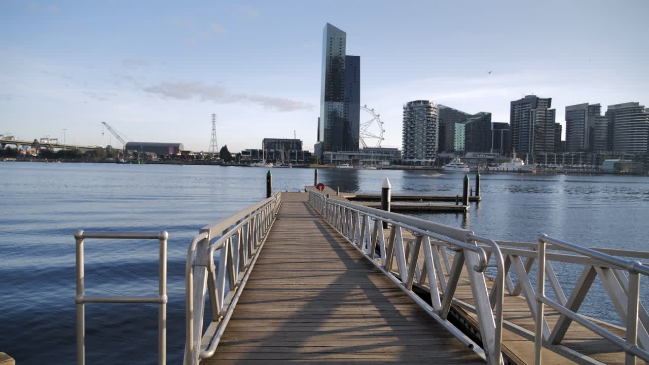 Docklands pier pan across with water on sunny day