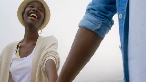 low angle view of african american couple walking with hand in hand on the beach 4k