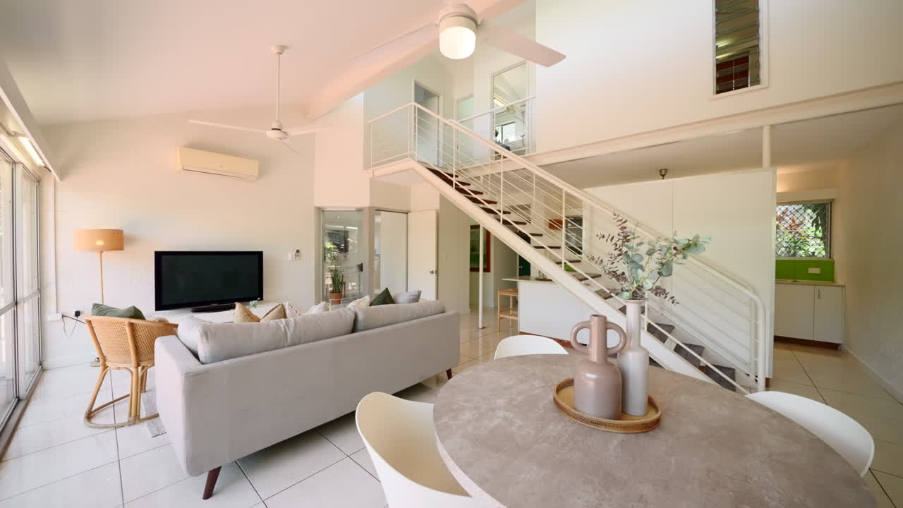 Wide Angle Establish of Urban Elevated Modern Home House Interior Loungeroom With Long Staircase and Tiled Floor