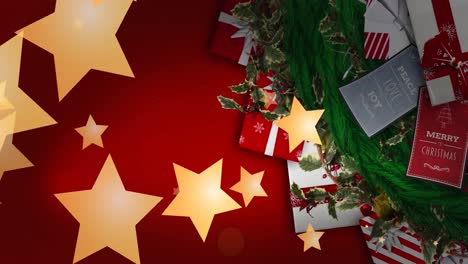 Animation-of-glowing-stars-falling-over-christmas-presents-on-red-background