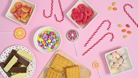 pastel pink theme full with sweets, candies, lollypops and chocolates moving. stop motion flat lay