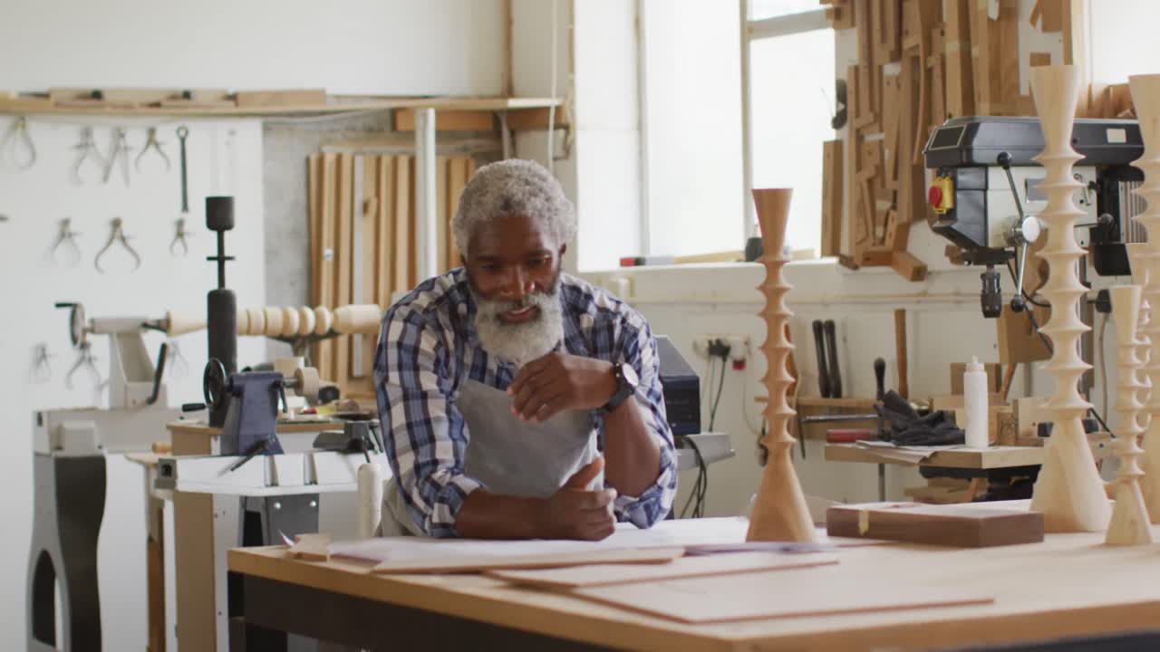 Portrait of african american male carpenter smiling at a carpentry shop