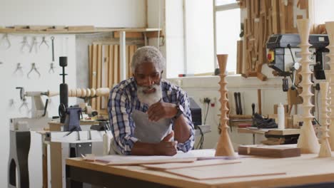 portrait of african american male carpenter smiling at a carpentry shop