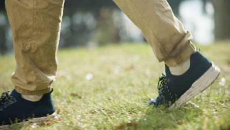 closeup, shoes and walking in nature grass