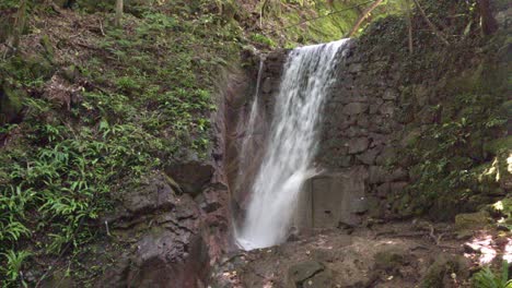 A man-made waterfall surrounded by nature near the Rastenbachklamm gore above Kaltern - Caldaro, South Tyrol, Italy