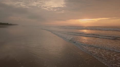 Establishing-shot-of-beach-in-early-morning-with-crazy-orange-color-of-sky-and-sun