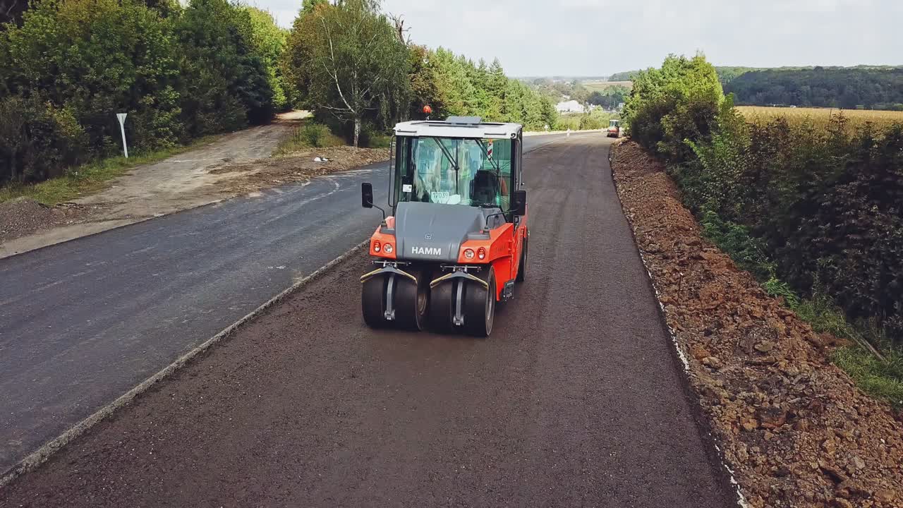 Modern heavy asphalt roller that stack and press hot asphalt. Repairing in modern city with vibration roller compactor