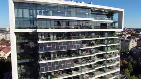 aerial views of a modern sustainable building featuring solar panels and innovative architecture, showcasing energy efficiency and contemporary design