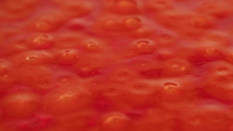 boiling tomato sauce on a frying pan close-up. cooking tomato sauce or soup. traditional italian mexican asian dish. high quality studio shot for cafe, restaurant close up. marinara sauce for italian pasta