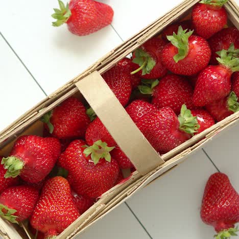 fresh healthy strawberries in a wooden box on white background